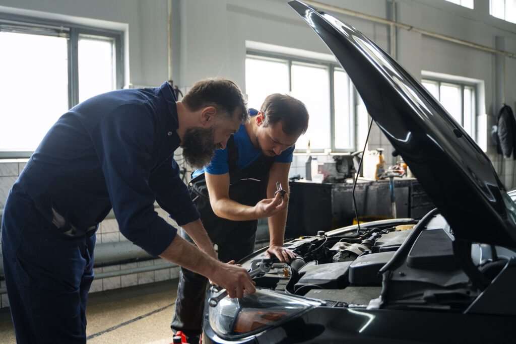 male mechanics-working together car shop